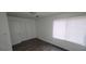 Bedroom featuring wood floors, closet, and window with blinds at 5796 Par Four Ct, Lithonia, GA 30038