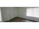 Bedroom with hardwood floors, a window, and a closet at 5796 Par Four Ct, Lithonia, GA 30038