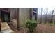 Weathered exterior highlighting a mature shrub and weathered wood at 5796 Par Four Ct, Lithonia, GA 30038