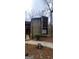 Rustic exterior showcasing aged wood and multiple stories with a weathered sidewalk at 5796 Par Four Ct, Lithonia, GA 30038
