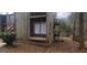 Rustic weathered exterior featuring a window with a wooden seat and small balcony at 5796 Par Four Ct, Lithonia, GA 30038