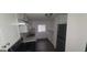 Bright kitchen with white cabinetry, hardwood floors, marble countertops, and stainless steel appliances at 5796 Par Four Ct, Lithonia, GA 30038