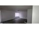 Well-lit living room with wood-look floors and large window at 5796 Par Four Ct, Lithonia, GA 30038