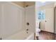 Bathroom featuring a clean white shower and toilet next to a window for natural light at 6192 Holiday Blvd, Forest Park, GA 30297