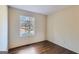 Bright bedroom with hardwood floors and a large window overlooking the outdoors at 6192 Holiday Blvd, Forest Park, GA 30297