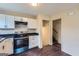 Modern kitchen with white cabinets, stainless steel appliances, and stylish black countertops at 6192 Holiday Blvd, Forest Park, GA 30297