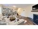 Inviting living room featuring a fireplace, built-in bookshelves, and comfortable seating with hardwood floors at 6192 Holiday Blvd, Forest Park, GA 30297