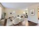 Bright, staged living room with hardwood floors, neutral walls, and modern furnishings leading to the dining area at 6192 Holiday Blvd, Forest Park, GA 30297