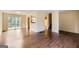 Bright living room featuring hardwood floors, sliding doors to a deck, and an open view to the kitchen at 6192 Holiday Blvd, Forest Park, GA 30297