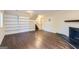 Inviting living room features custom built-in shelving, a cozy fireplace, and hardwood floors at 6192 Holiday Blvd, Forest Park, GA 30297