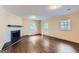 Spacious living room featuring a fireplace, large windows, and hardwood floors at 6192 Holiday Blvd, Forest Park, GA 30297