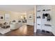 Bright, staged living room with hardwood floors, neutral walls, and modern furnishings leading to the dining area at 6192 Holiday Blvd, Forest Park, GA 30297