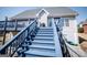 Exterior shot of backyard with a blue deck and staircase leading from the house at 106 Victoria Way, Carrollton, GA 30116