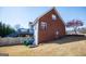 Expansive backyard view featuring a deck, brick exterior, and mature trees at 106 Victoria Way, Carrollton, GA 30116