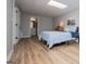 Bedroom features wood look flooring, overhead lighting, and a comfortable bed at 106 Victoria Way, Carrollton, GA 30116