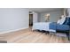Bedroom features wood look flooring, overhead lighting, a comfortable bed, and an ensuite bath at 106 Victoria Way, Carrollton, GA 30116