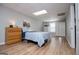 Bedroom with wood look flooring, neutral paint, overhead lighting, bed, dresser, and closet at 106 Victoria Way, Carrollton, GA 30116