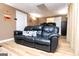 Basement living room with wood look flooring and comfortable couches at 106 Victoria Way, Carrollton, GA 30116