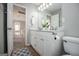 Bright bathroom features a double vanity and a view of the hallway at 106 Victoria Way, Carrollton, GA 30116