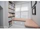 Corner of the bonus room with window seat, plaid cushions and built-in bookcase at 106 Victoria Way, Carrollton, GA 30116