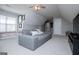 Carpeted bonus room offers ample living space with a large gray sofa at 106 Victoria Way, Carrollton, GA 30116