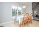 Charming breakfast nook with bright windows, wood table and chairs at 106 Victoria Way, Carrollton, GA 30116