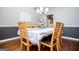 Well-lit dining room features modern furnishings, hardwood flooring, and a stylish light fixture at 106 Victoria Way, Carrollton, GA 30116