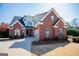 Beautiful two-story brick home boasts a pristine lawn, covered entrance, attached garage and well-maintained landscaping at 106 Victoria Way, Carrollton, GA 30116