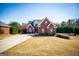 An attractive two-story brick home with a well-manicured lawn, an attached garage and a welcoming facade at 106 Victoria Way, Carrollton, GA 30116