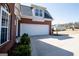 Spacious two-car garage with a paved driveway and landscaping at 106 Victoria Way, Carrollton, GA 30116