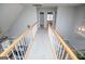 Upstairs hallway with gray carpet and white wood railings at 106 Victoria Way, Carrollton, GA 30116