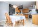 Kitchen with wooden cabinets, granite countertops, breakfast table, and pendant lighting at 106 Victoria Way, Carrollton, GA 30116