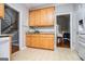 Kitchen features tile flooring, wood cabinetry, and access to the breakfast and living areas at 106 Victoria Way, Carrollton, GA 30116