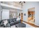 Cozy living room with a view to the kitchen, light gray walls, hardwood floors, and a comfortable leather sofa at 106 Victoria Way, Carrollton, GA 30116