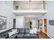 Open-concept living room featuring a soaring foyer, hardwood floors, and comfortable seating with natural light at 106 Victoria Way, Carrollton, GA 30116