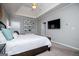 Relaxing bedroom with tray ceiling, wall decor, and a large flat screen TV at 106 Victoria Way, Carrollton, GA 30116