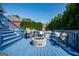 Blue outdoor deck with seating and a stone fire pit at 106 Victoria Way, Carrollton, GA 30116