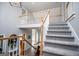 View of the staircase with light gray carpet and white wood railings at 106 Victoria Way, Carrollton, GA 30116