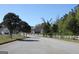 Street view of neighborhood featuring white picket fence and tree lined street at 7921 Chadwick Ln, Riverdale, GA 30274