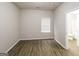 Neat, wood-floored bedroom with bright window and neutral decor at 139 Surge Stone Ln, Stockbridge, GA 30281