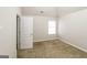 Cozy bedroom featuring plush carpeting and a window offering natural light at 139 Surge Stone Ln, Stockbridge, GA 30281