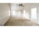 Spacious bedroom with plush carpeting, ceiling fan, and abundant natural light at 139 Surge Stone Ln, Stockbridge, GA 30281