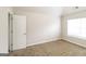 Bright, carpeted bedroom with ample sunlight streaming through the window at 139 Surge Stone Ln, Stockbridge, GA 30281