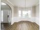 Elegant dining area with wood floors, wainscoting, and a chandelier creating an inviting ambiance at 139 Surge Stone Ln, Stockbridge, GA 30281