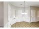 Bright dining room featuring a modern chandelier, and wood floors, with a door leading outside at 139 Surge Stone Ln, Stockbridge, GA 30281