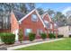 Side view of a two story brick home with an attached garage and well-maintained landscaping at 139 Surge Stone Ln, Stockbridge, GA 30281
