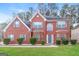 Charming two-story red brick home with a manicured front lawn and gray shutters adding curb appeal at 139 Surge Stone Ln, Stockbridge, GA 30281