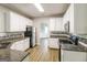 Modern kitchen with white cabinets, granite countertops, stainless steel appliances, and wood floors at 139 Surge Stone Ln, Stockbridge, GA 30281