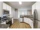 Open concept kitchen featuring stainless steel appliances, granite countertops, and white cabinetry at 139 Surge Stone Ln, Stockbridge, GA 30281