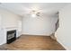 Bright living room featuring wood floors, a fireplace, and staircase with carpeted steps at 139 Surge Stone Ln, Stockbridge, GA 30281